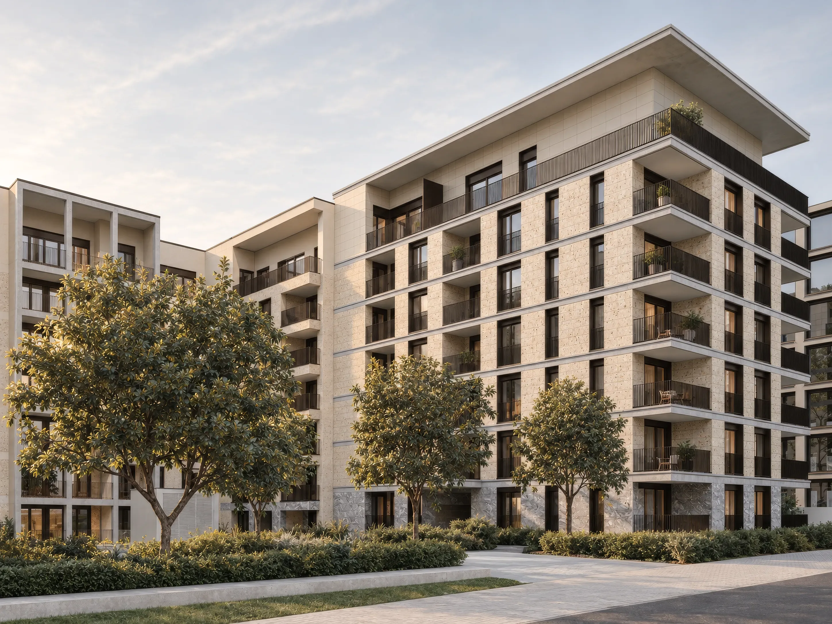 Montera depuis les jardins — arbres et massifs au premier plan, loggias en enfilade sur la façade en pierre claire