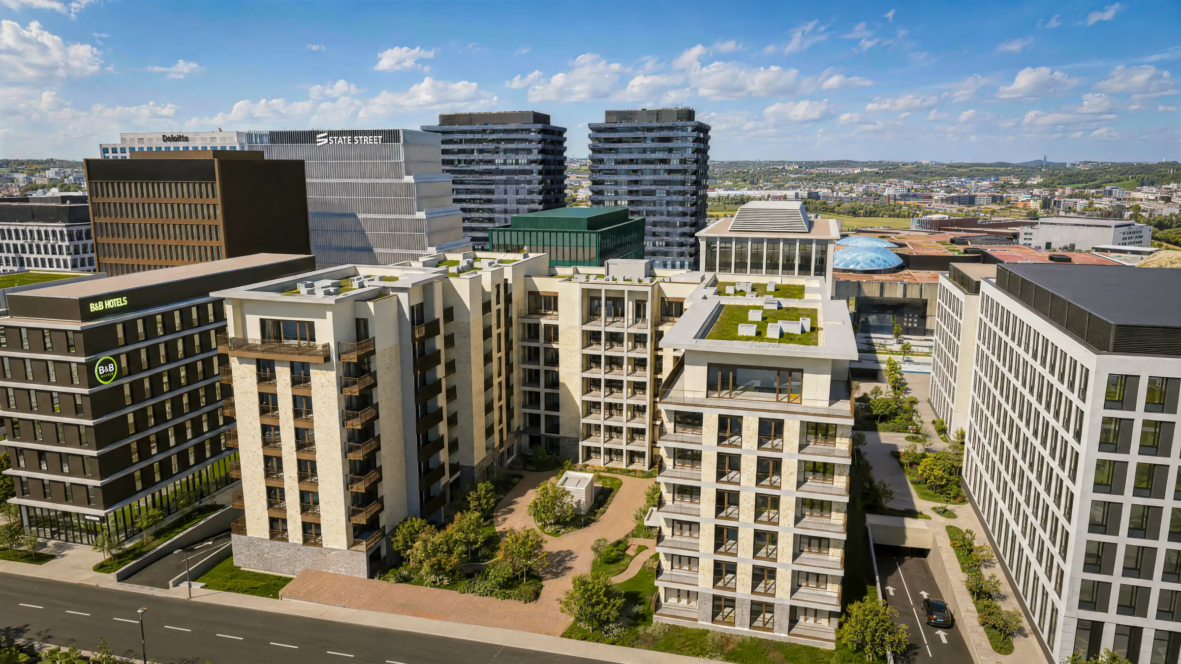 Aerial view of MONTERA in Cloche d'Or: the residences around the landscaped heart, among the district's office towers